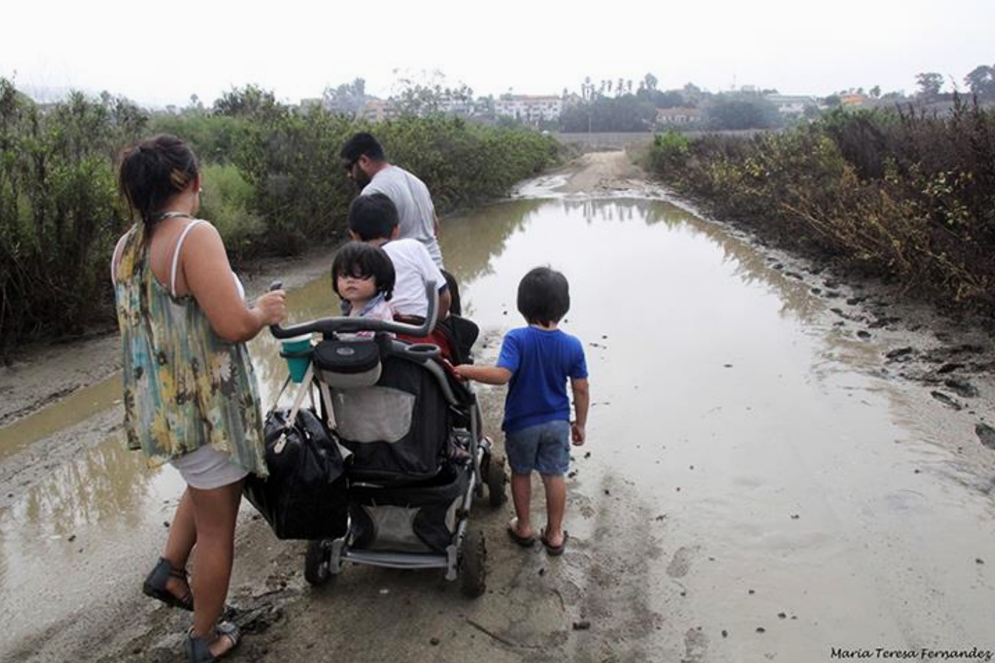 A family blocked by water flooding the path.