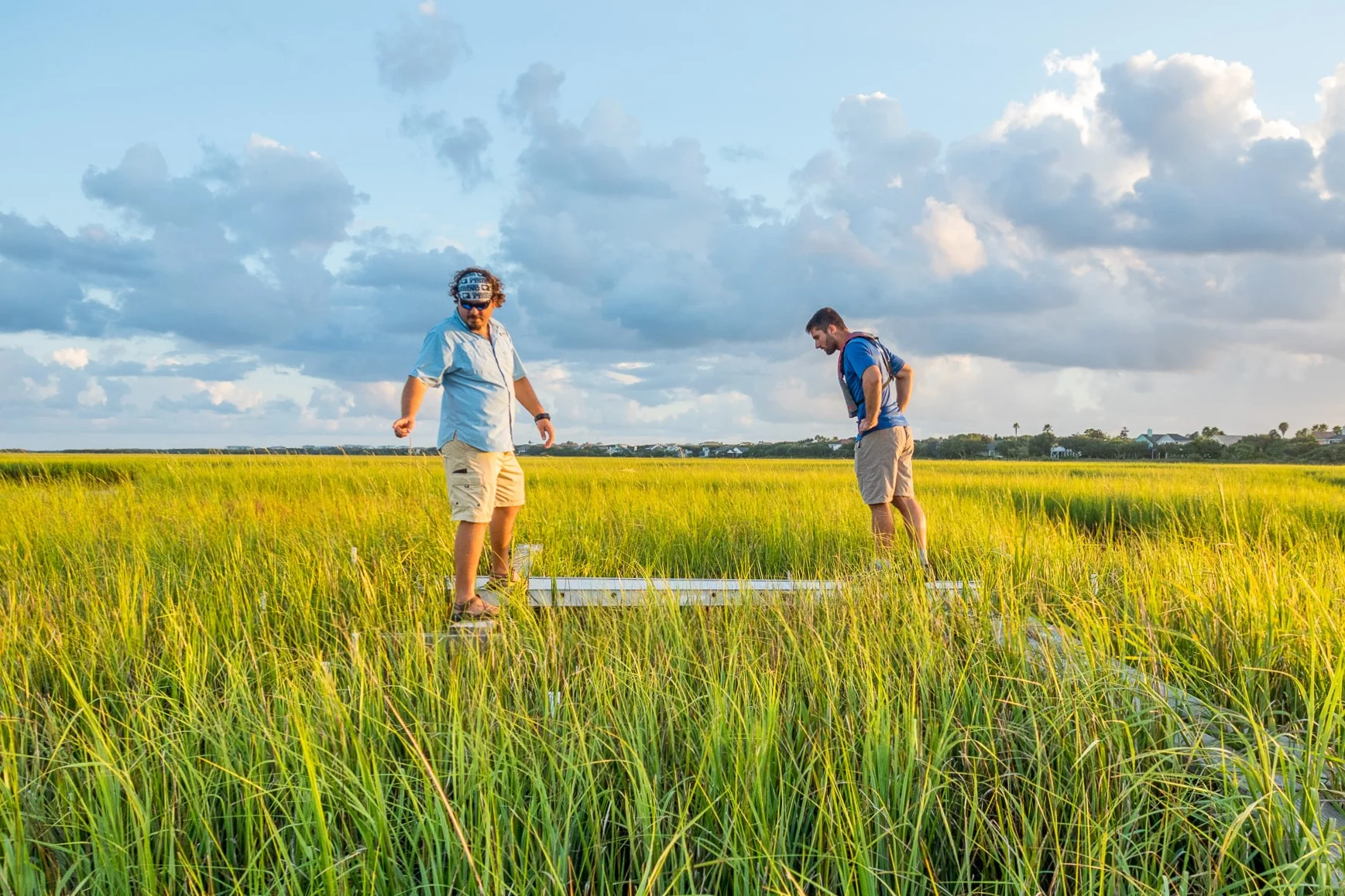 Two people standing on a table in the middle of a field