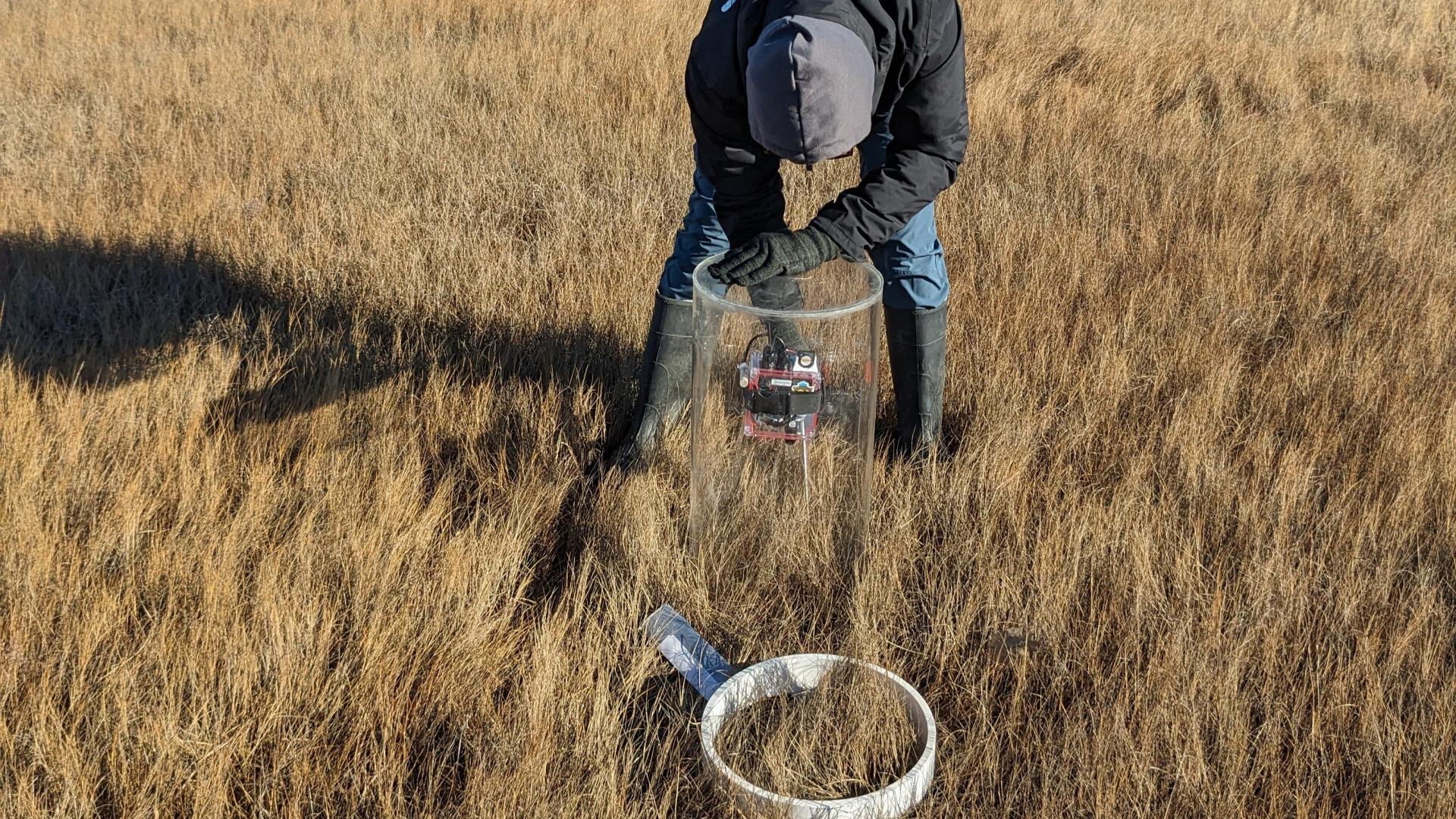 Person bending over to set up cylinder sensor