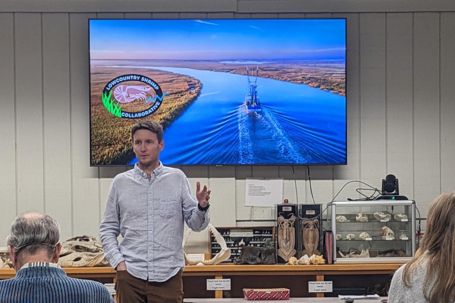 Individual presenting in front of flat screen television