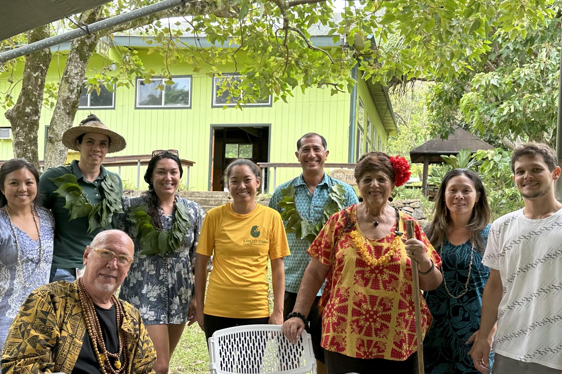 People standing in front of a house for a group photo.