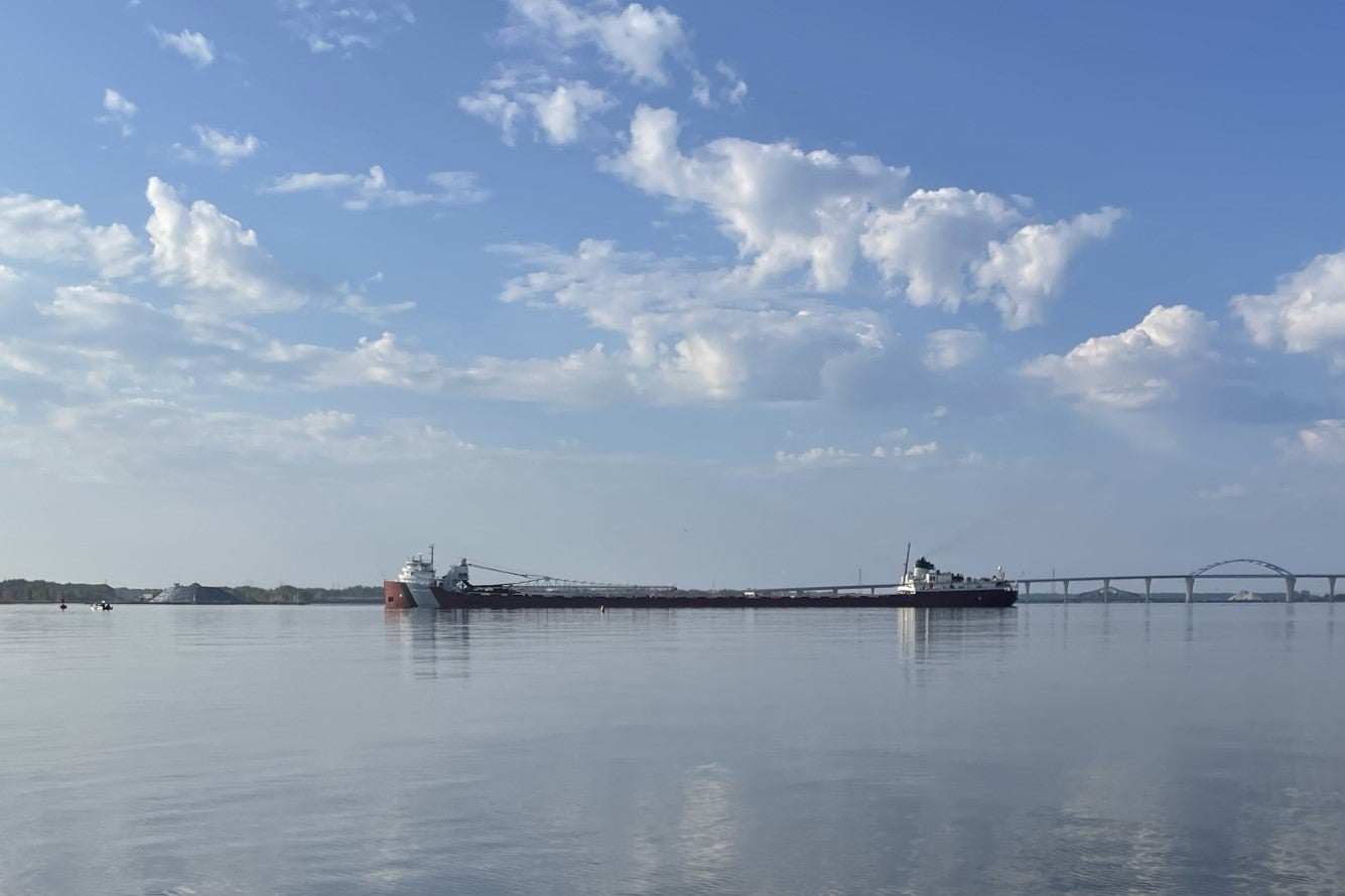 A large cargo ship sitting on the water.